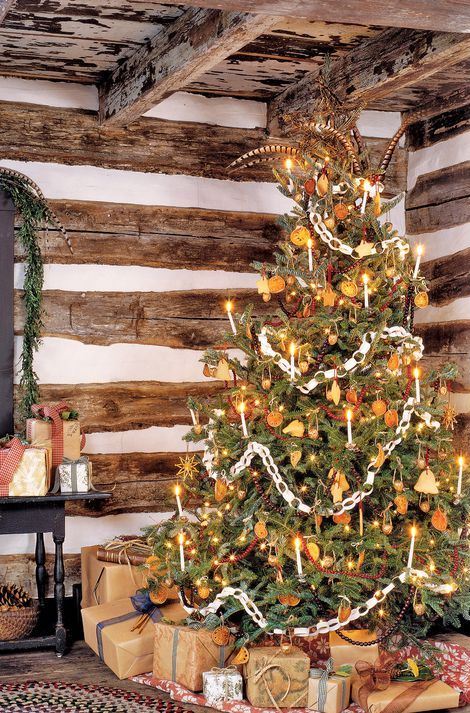 A Vintage Christmas Tree Decorated With Lights Citrus Slices Stars Cranberry Garlands Paper Chain and other stuff